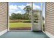 The screened porch with golf course views offers a relaxing space to enjoy the outdoors, featuring plush flooring at 964 Great Egret Circle Sw # B, Sunset Beach, NC 28468