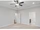 Neutral carpeted bedroom with ceiling fan and access to a walk-in closet at 1004 Fowler Rd., Conway, SC 29526