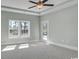 Bedroom with ceiling fan, two windows and glass pane door to rear yard at 1004 Fowler Rd., Conway, SC 29526