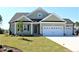 Charming home with a two-car garage, manicured lawn, and inviting front porch at 1004 Fowler Rd., Conway, SC 29526