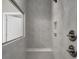 Neutral tiled shower with glass accent window and built-in seat at 1004 Fowler Rd., Conway, SC 29526