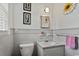 Clean bathroom featuring white tiled walls, a neutral floor, and vanity with ample counter space at 1008 N Withlacoochee Ave., Marion, SC 29571