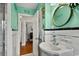 Hall bathroom with stylish mint green walls, vintage black and white tile and a stylish mirror at 1008 N Withlacoochee Ave., Marion, SC 29571