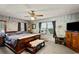 Bedroom features a large bed, exposed brick walls, ceiling fan, and is filled with natural light at 1008 N Withlacoochee Ave., Marion, SC 29571