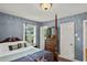 Bedroom featuring a four-poster bed, neutral carpet and pastel blue walls at 1008 N Withlacoochee Ave., Marion, SC 29571
