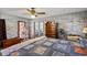 Large bedroom with a classic ceiling fan, exposed brick wall and view to another room at 1008 N Withlacoochee Ave., Marion, SC 29571