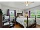 Bedroom with a ceiling fan and views of outside from two windows at 1008 N Withlacoochee Ave., Marion, SC 29571