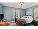 Cozy bedroom featuring a four-poster bed, soft lighting, and ample natural light at 1008 N Withlacoochee Ave., Marion, SC 29571