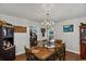 Charming dining room with hardwood floors, chandelier lighting, and a glimpse into other rooms at 1008 N Withlacoochee Ave., Marion, SC 29571