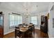 Bright dining room with wood floors, stylish lighting, and charming window treatments, perfect for Gathering gatherings at 1008 N Withlacoochee Ave., Marion, SC 29571