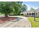 Long, paved driveway leads to a home with a covered carport and landscaped yard at 1008 N Withlacoochee Ave., Marion, SC 29571