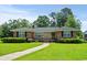 Charming brick home with a well-maintained lawn and inviting front porch at 1008 N Withlacoochee Ave., Marion, SC 29571
