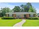 Charming brick home with a well-maintained lawn and inviting front porch at 1008 N Withlacoochee Ave., Marion, SC 29571