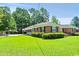 Well-manicured lawn and landscaped yard with a charming brick home in the background at 1008 N Withlacoochee Ave., Marion, SC 29571