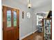 Inviting foyer with decorative glass door, hardwood floors, unique architectural details, and a charming vintage display cabinet at 1008 N Withlacoochee Ave., Marion, SC 29571