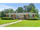 Charming brick home with a well-maintained lawn, lush green landscaping, and inviting walkway, perfect for families at 1008 N Withlacoochee Ave., Marion, SC 29571