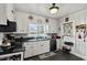 Functional kitchen with black appliances, white cabinets, and a window providing natural light, perfect for home cooking at 1008 N Withlacoochee Ave., Marion, SC 29571