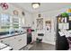 Well-lit kitchen with white cabinets, stainless steel appliances, a window overlooking the yard, and a convenient back door at 1008 N Withlacoochee Ave., Marion, SC 29571