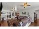 Open-concept living room featuring hardwood floors, a comfortable seating area, and access to an adjacent room through French doors at 1008 N Withlacoochee Ave., Marion, SC 29571