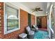 Charming porch with comfortable seating and brick facade for relaxation and enjoying the outdoors at 1008 N Withlacoochee Ave., Marion, SC 29571