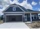 New construction two-story home with a two-car garage featuring stone accents and a modern design at 1010 Black Locust Pl., Longs, SC 29568