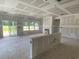 Living room under construction featuring a fireplace, large windows, and access to the outdoors at 1010 Black Locust Pl., Longs, SC 29568