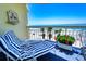 Comfortable balcony seating with picturesque ocean view and tropical ambiance at 1012 N Waccamaw Dr. # 305, Garden City Beach, SC 29576