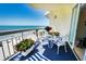 Balcony view with table and chairs to enjoy the beach view at 1012 N Waccamaw Dr. # 305, Garden City Beach, SC 29576