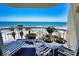 Inviting balcony with table set for brunch and breathtaking views of the ocean at 1012 N Waccamaw Dr. # 305, Garden City Beach, SC 29576