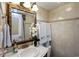 Elegant bathroom features tiled walls and a decorative mirror over the vanity at 1012 N Waccamaw Dr. # 305, Garden City Beach, SC 29576