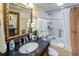 Bathroom with a tiled shower/tub, a vanity, and fresh white towels at 1012 N Waccamaw Dr. # 305, Garden City Beach, SC 29576