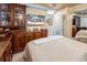 Bedroom featuring custom cabinetry, a television, and mirrored closet doors at 1012 N Waccamaw Dr. # 305, Garden City Beach, SC 29576
