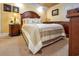 Cozy bedroom with a wooden headboard, custom-built cabinets, and warm lighting at 1012 N Waccamaw Dr. # 305, Garden City Beach, SC 29576