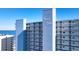 Exterior view of Water's Edge Resort showcasing architectural design against a clear, blue sky at 1012 N Waccamaw Dr. # 305, Garden City Beach, SC 29576