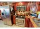Modern kitchen featuring stainless steel appliances, granite countertops, and wood cabinets at 1012 N Waccamaw Dr. # 305, Garden City Beach, SC 29576
