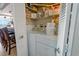 Convenient laundry area with stackable washer/dryer and storage shelves near kitchen at 1012 N Waccamaw Dr. # 305, Garden City Beach, SC 29576