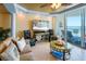 Cozy living area with comfortable sofa, tv, and sliding door to balcony at 1012 N Waccamaw Dr. # 305, Garden City Beach, SC 29576