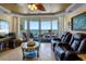 Bright living room with ocean views, stylish furniture, and access to balcony at 1012 N Waccamaw Dr. # 305, Garden City Beach, SC 29576