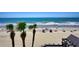 Panoramic ocean view from the beach with palm trees and beachgoers at 1012 N Waccamaw Dr. # 305, Garden City Beach, SC 29576