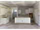Bright, unfinished kitchen featuring white cabinets, a center island and an open layout for seamless entertaining at 1014 Black Locust Pl., Longs, SC 29568