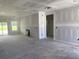 Spacious living room with smooth, white walls, an unfinished floor, and bright, natural light from a window at 1014 Black Locust Pl., Longs, SC 29568