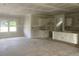 An unfinished living room featuring an open layout, unfinished flooring, and natural light streaming through large windows at 1014 Black Locust Pl., Longs, SC 29568
