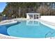 Beautiful in-ground swimming pool area features a covered gazebo and lounge chairs for relaxing in the sun at 1014 Black Locust Pl., Longs, SC 29568