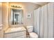 Well-lit bathroom featuring a vanity, mirror, and shower, offering a fresh and functional space at 121 Easy St., Garden City Beach, SC 29576