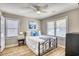 Bright bedroom with a wrought iron bed, coastal decor, and ample natural light from two windows at 121 Easy St., Garden City Beach, SC 29576