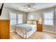 Inviting bedroom with wood floors, a fan, and ample natural light at 121 Easy St., Garden City Beach, SC 29576