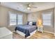 Charming bedroom with a ceiling fan, nautical decor, and two windows, creating a cozy retreat at 121 Easy St., Garden City Beach, SC 29576