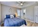 Comfortable bedroom features a ceiling fan, a nautical-themed wheel decoration, and a white nightstand at 121 Easy St., Garden City Beach, SC 29576