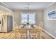 Dining room features a wooden table set for six, next to the kitchen and window at 121 Easy St., Garden City Beach, SC 29576