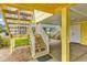 Ground level view showcases stairs leading to an elevated beach house at 121 Easy St., Garden City Beach, SC 29576